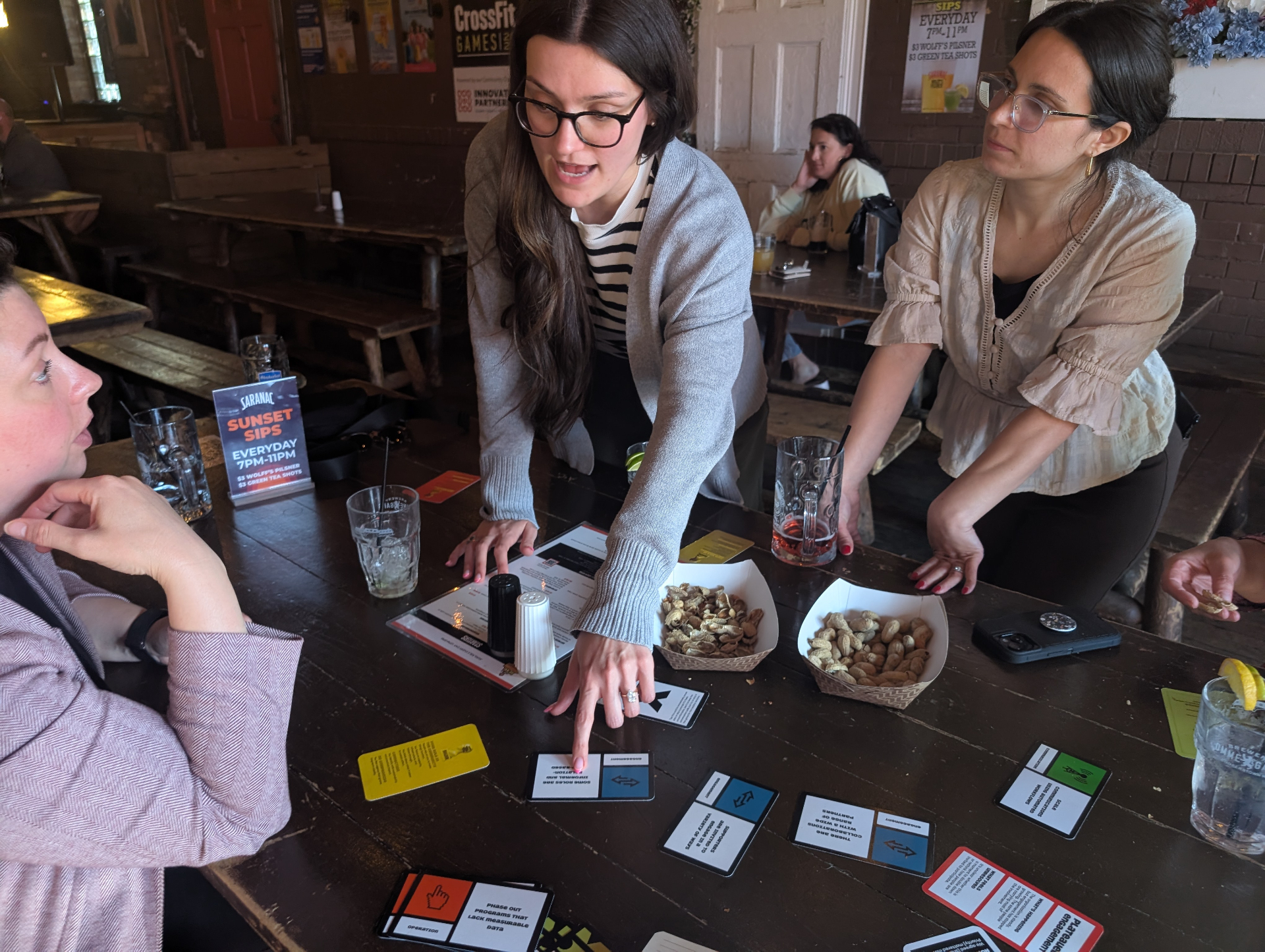 Players gathered around a pub table mid-game