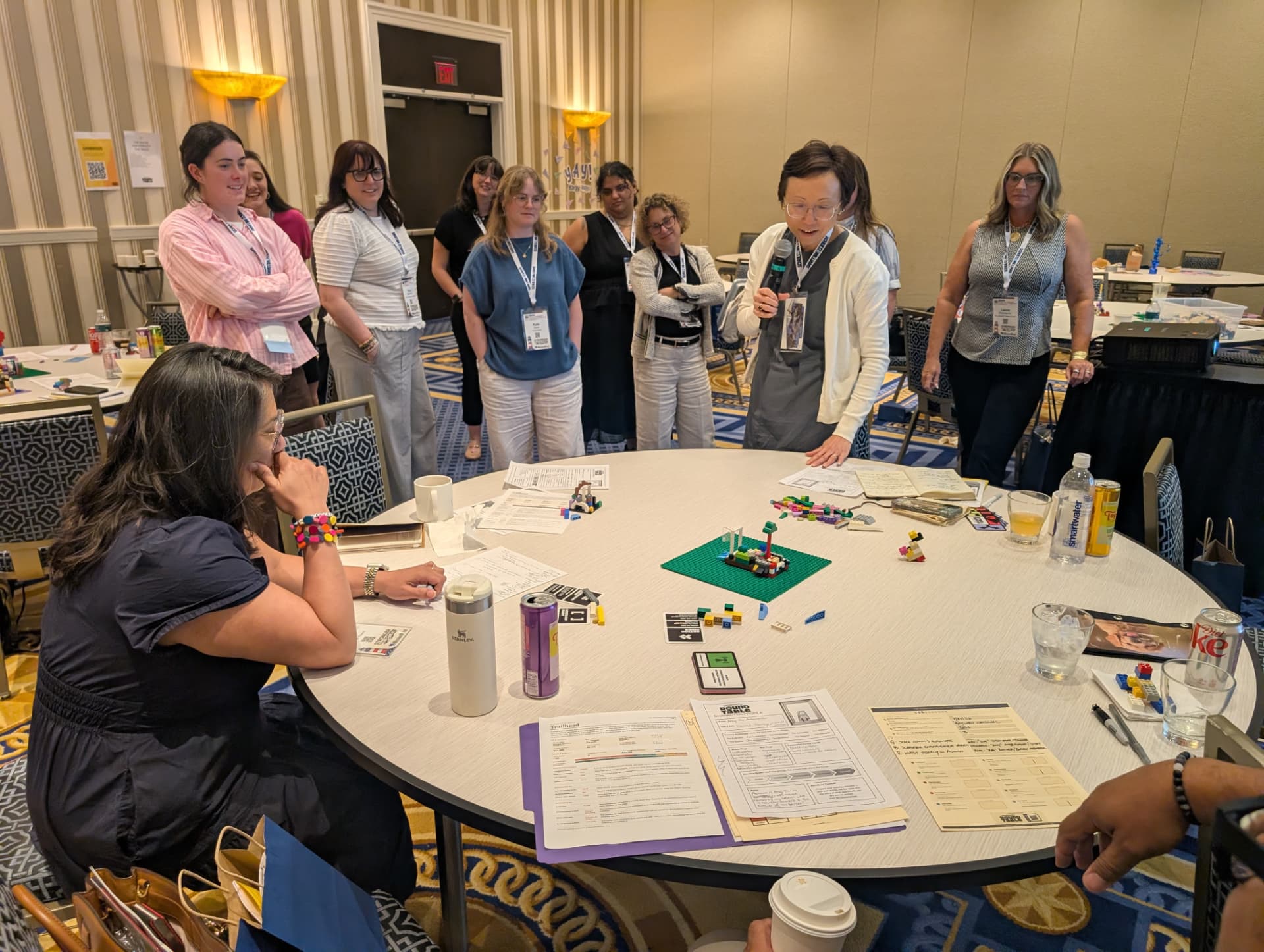 Sharing out loud — a Host walks the room through her table's Trailhead.
