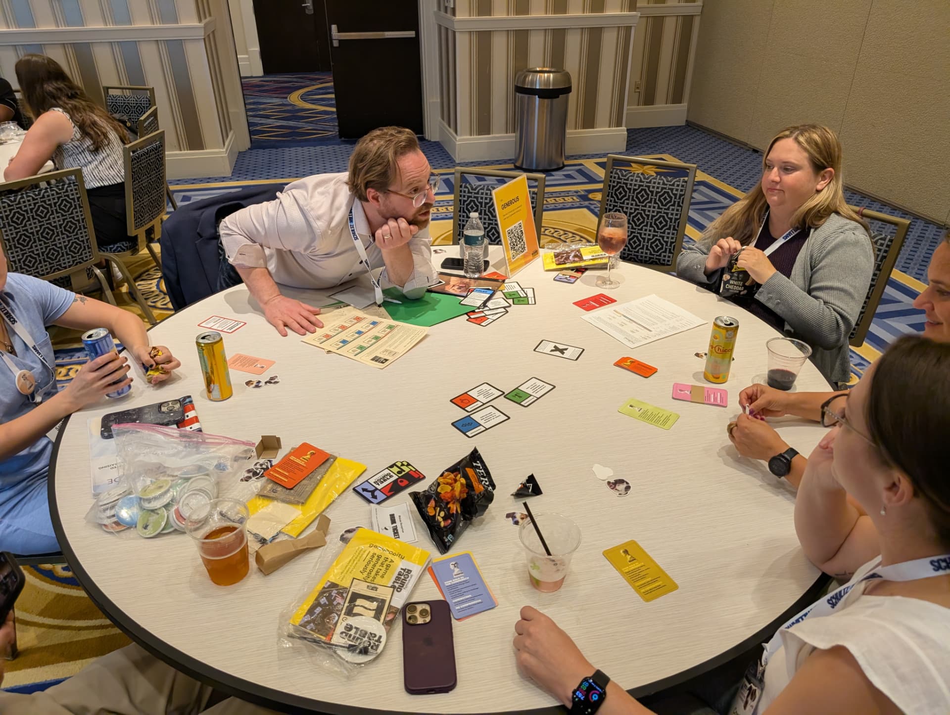 Another after-party table at Bridge — cards out, snacks open, everyone still in it.