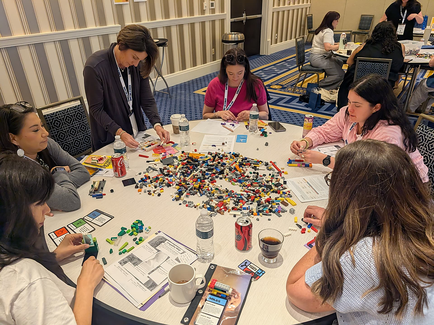 Participants building with LEGO bricks during a Generosity Roundtable workshop