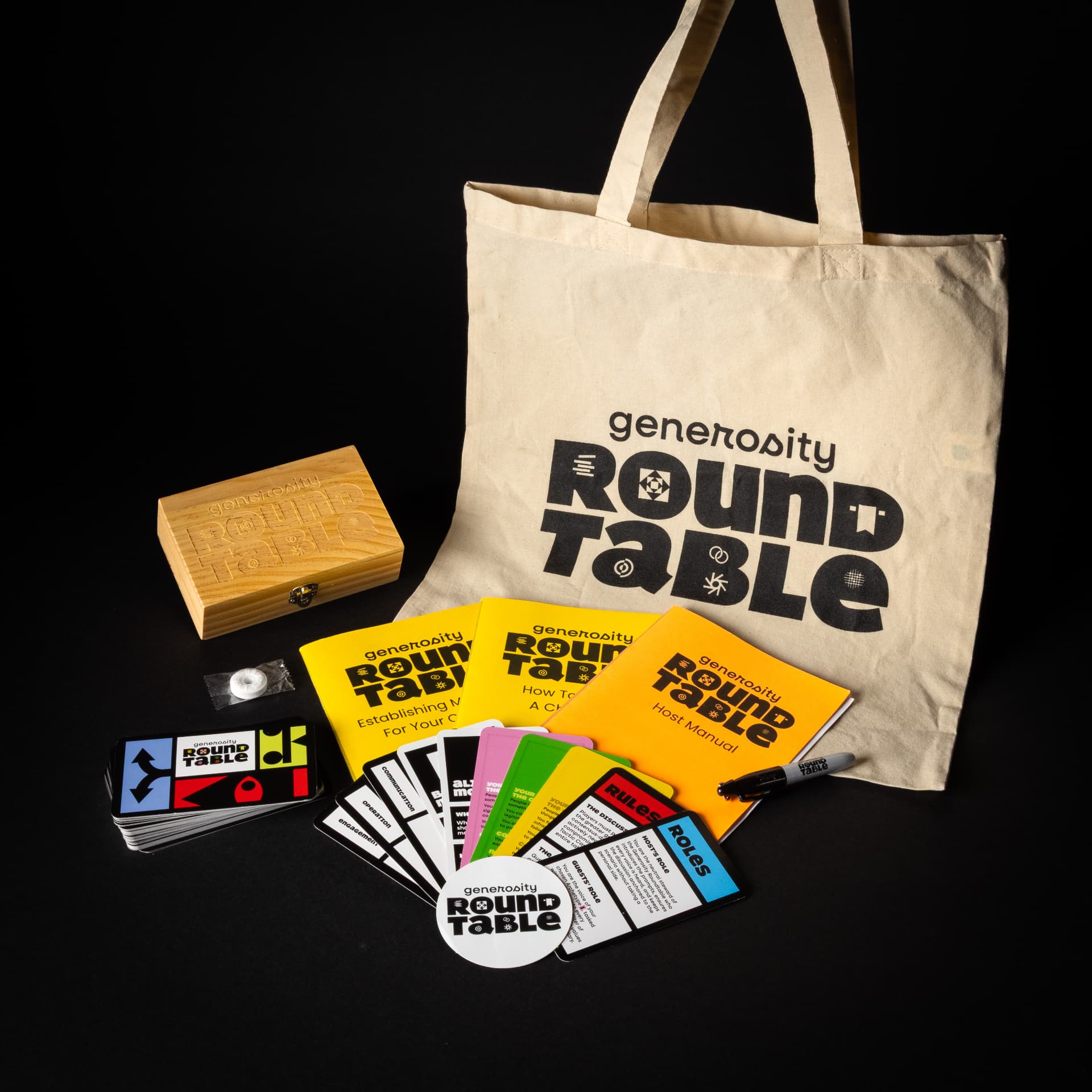 The Generosity Roundtable educational gaming system box with its canvas tote bag